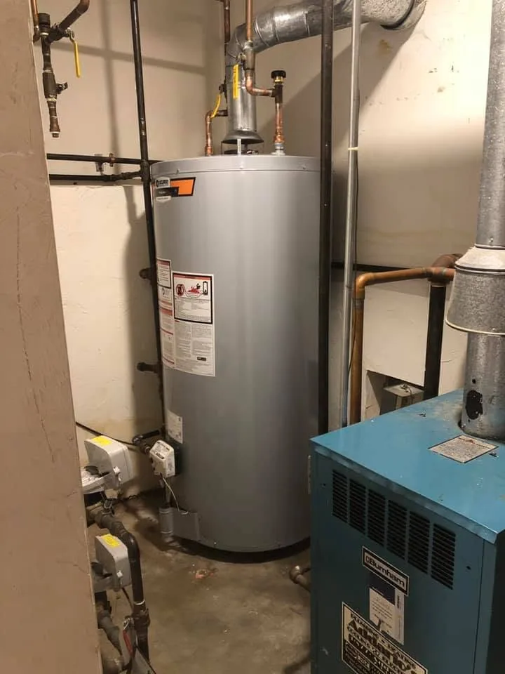 Gray gas water heater beside blue burnham boiler melrose medford